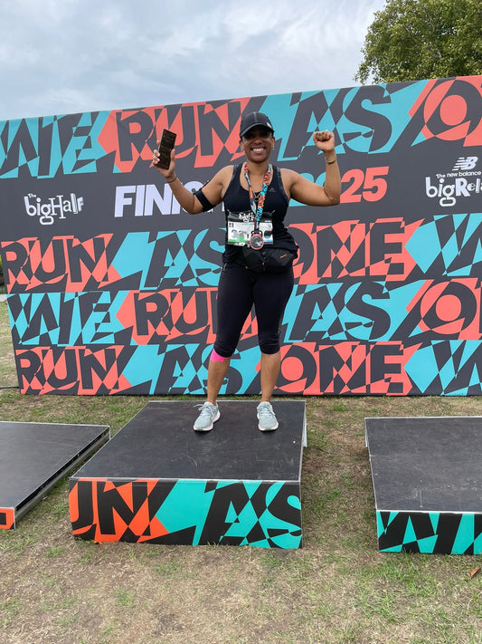 Black woman standing on the center of the Bighalf podium